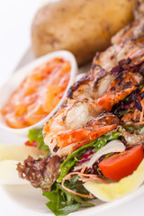 Grilled prawns with endive salad and jacket potato