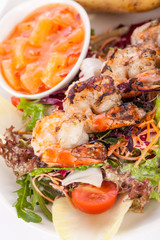 Grilled prawns with endive salad and jacket potato