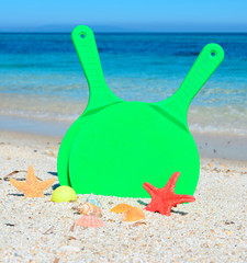 Fototapeta na wymiar green rackets and sand