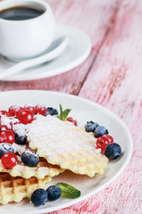 Waffles with fresh berries on the table