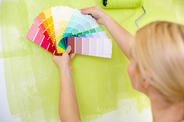 Woman with scale of paint swatches