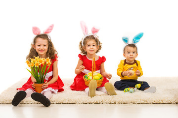 Three kids with bunny ears in a row