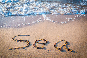 Fototapeta na wymiar Writing Sea on the Beach in Thailand