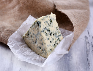 Tasty blue cheese, on wooden table