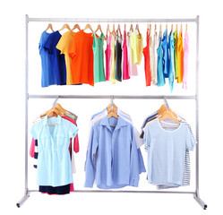 Different clothes on hangers, on gray background