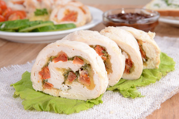 Delicious chicken roll on plate on table close-up