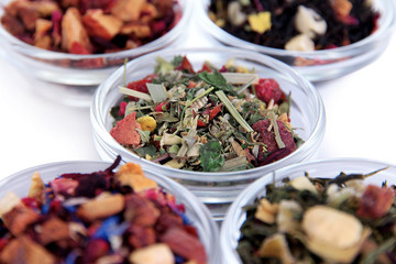 Different kinds of dry tea in bowls close up
