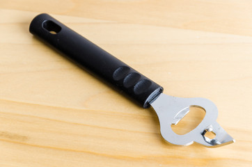 Can opener on wood background