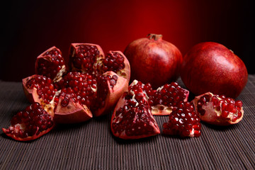 Ripe pomegranates on table close-up