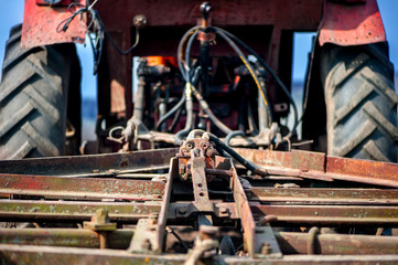 Fototapeta na wymiar Close-up detail of tractor or machine harvesting the field