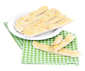 Tasty bread sticks on plate isolated on white