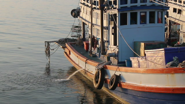 Fishing boats moored at the dock discharge, full HD.