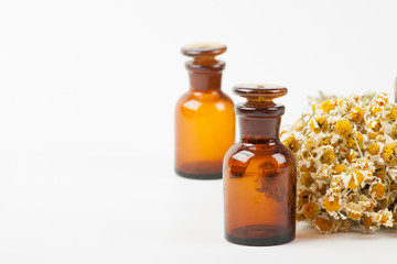 Dry chamomile and a bottles