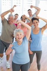 Portrait of smiling people doing power fitness exercise