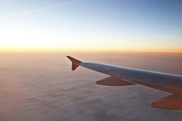 Fototapeta na wymiar Flying plane above the clouds