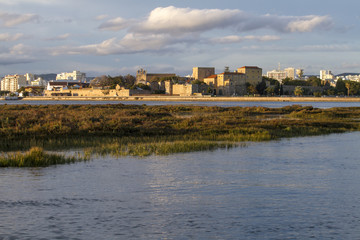 Obraz premium city of Faro, Portugal, creating a reflection on the water.