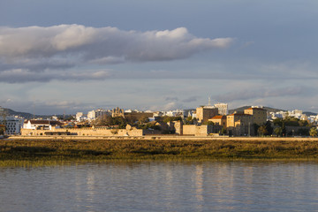 Obraz premium city of Faro, Portugal, creating a reflection on the water.