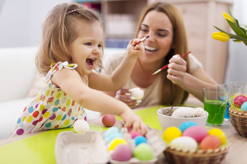 Obraz na płótnie Canvas Happy time while painting easter eggs