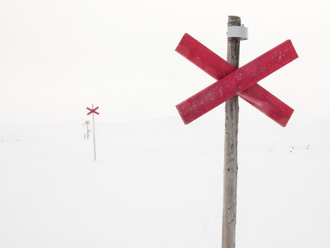 Route markers through arctic winter landscape