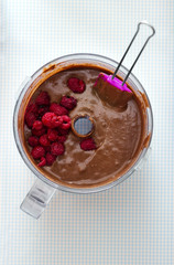 Making Cake - Mixing chocolate batter with raspberries 