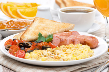 scramble eggs with tomatoes, grilled sausages and toast on plate