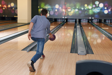 Man during the throwing bowling ball - obrazy, fototapety, plakaty