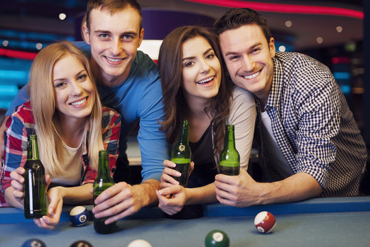 Party with friends in nightclub with billiards