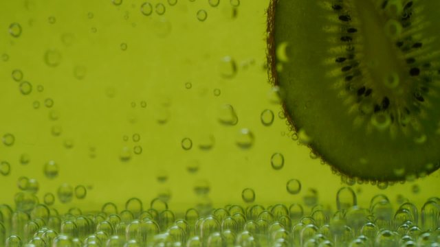 kiwi in aerated water on green background