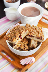 Jam filled bar cookies and cup of hot cocoa