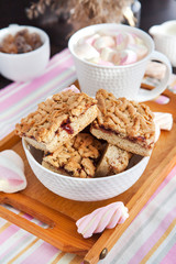 Jam filled bar cookies and cup of hot cocoa