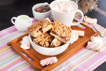 Jam filled bar cookies and cup of hot cocoa