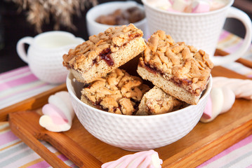 Jam filled bar cookies and cup of hot cocoa