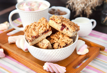 Jam filled bar cookies and cup of hot cocoa