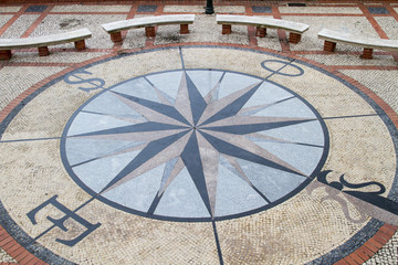 Fototapeta na wymiar View of a stone pavement mosaic of a wind rose pattern.