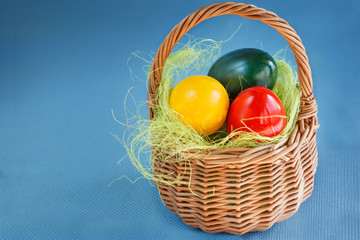 Easter Eggs Painted with red, yellow colors and green in the Bas