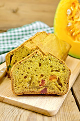 Fruitcake pumpkin with candied fruit and knife on board