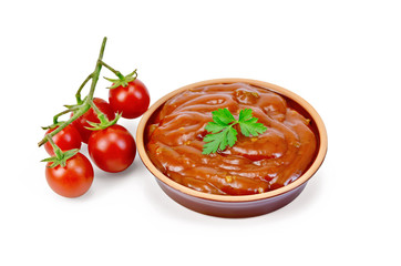 Ketchup in pottery with tomatoes