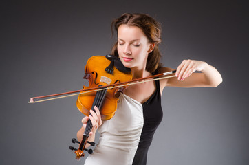 Woman artist with violin in music concept