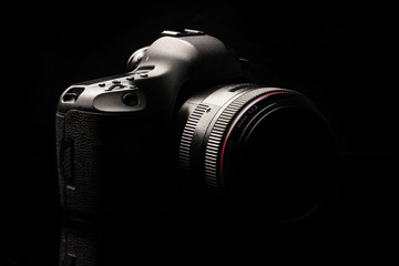 Professional modern DSLR camera low key image