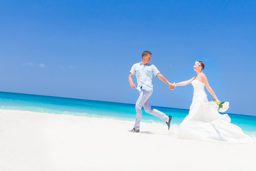 young loving couple on wedding day on tropical sand beach