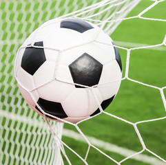 Naklejka na ściany i meble soccer ball in the goal net