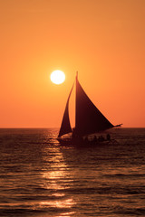 Fototapeta na wymiar Sailing boat at sunset