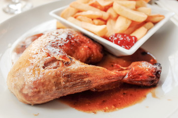 Chicken with sauce and golden French fries