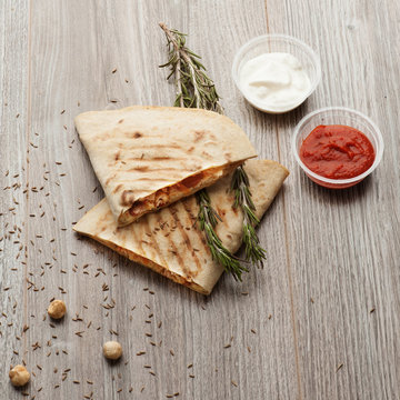 Mexican quesidilla, tomato sauce, cream sauce, fresh herbs.