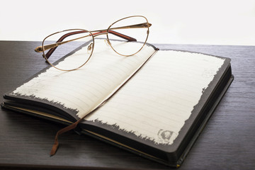 glasses and notebook on a table
