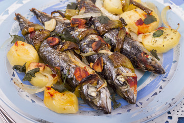 Close up view of cooked mackerel fish with potato.