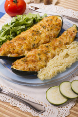 meat and vegetables zucchini halves with rice