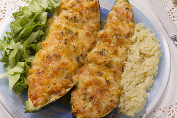 meat and vegetables zucchini halves with rice