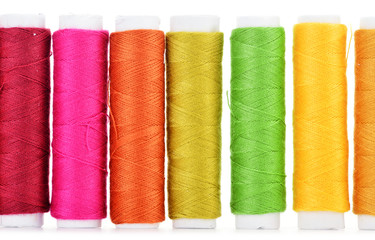 Composition with tailor threads over white background