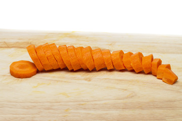 sliced pieces of carrot with knife.